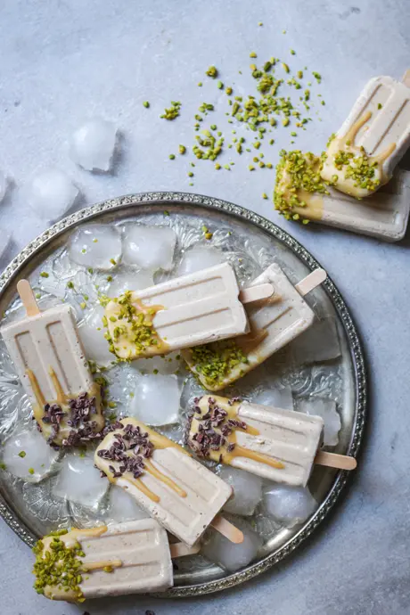 Karamelliges veganes Eis am Stiel mit Kakaonibs und Pistazien