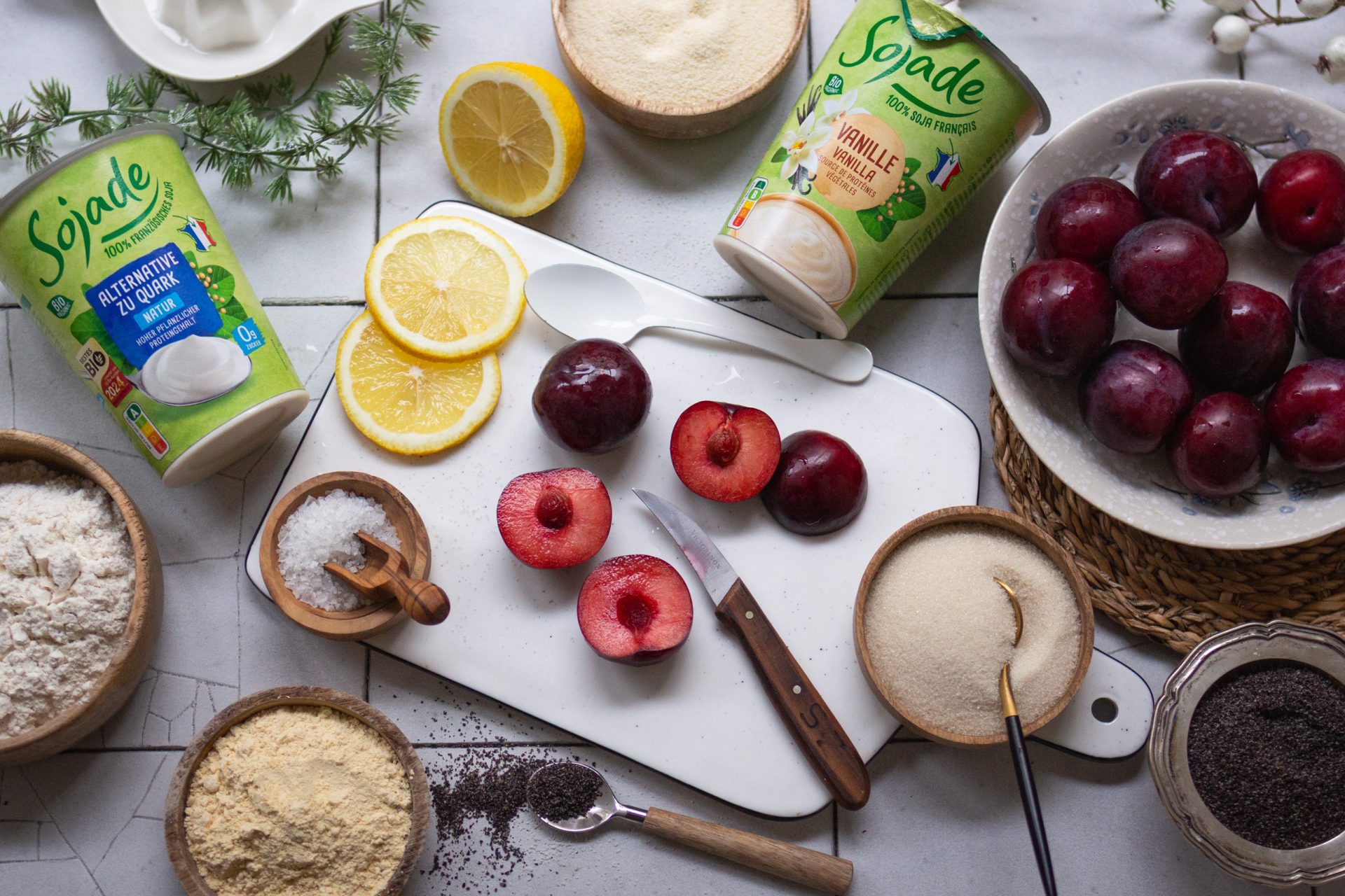 Zutaten für die Zubereitung von veganen Topfenknödeln mit Zwetschken und Mohn auf einer Arbeitsfläche